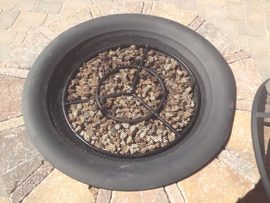 Screen, steel fire ring and pea gravel in fire pit pan