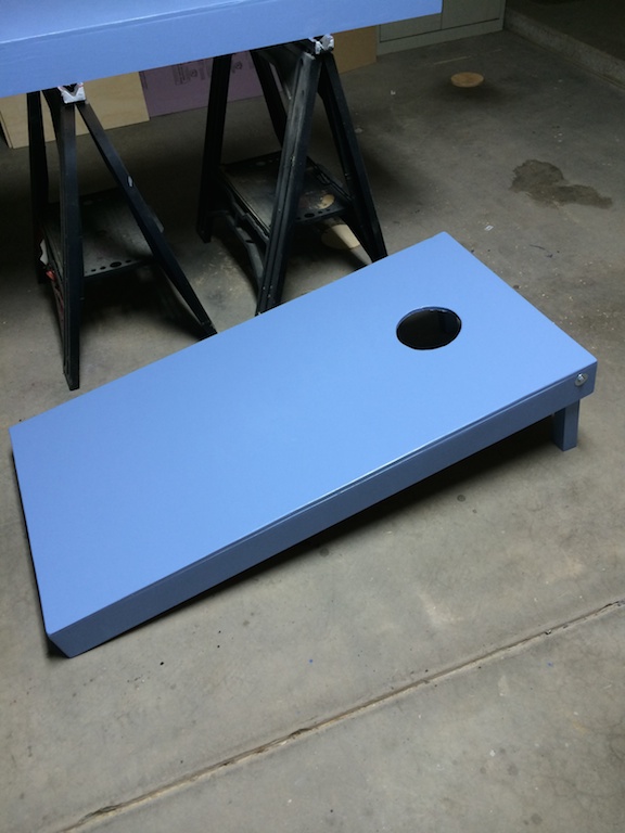 Cornhole board painted in meltmedia blue