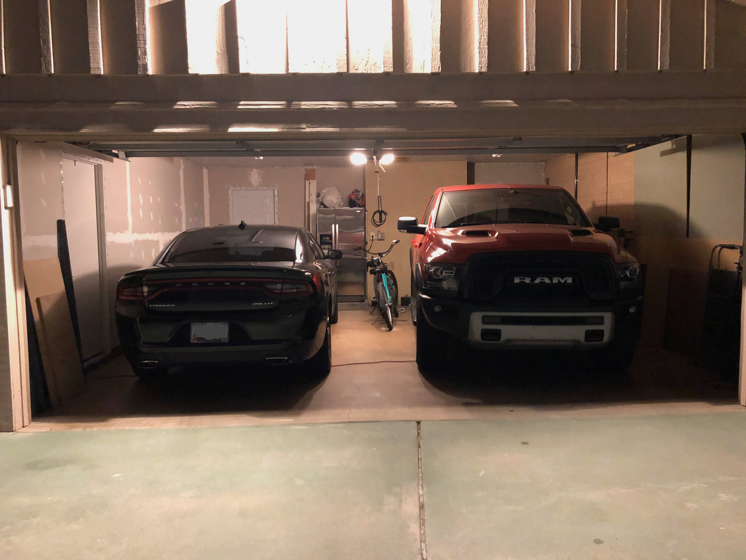 A two-car garage with two cars inside