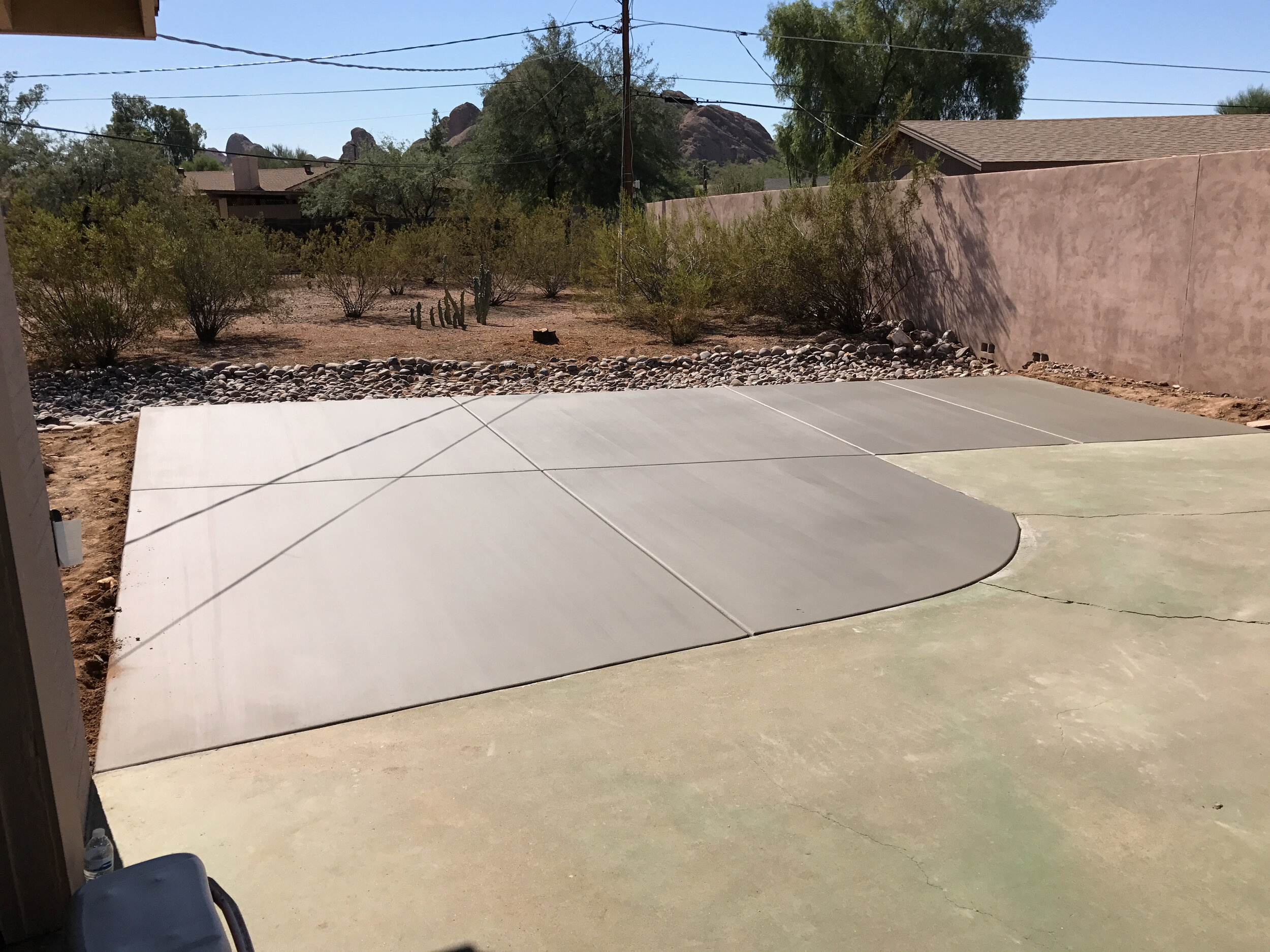 Completed surface of new concrete extension to old green driveway