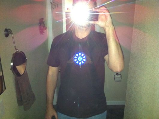 Clearly visible, even with a flash and dark brown shirt